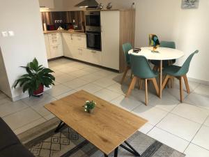 a kitchen and living room with a table and chairs at LES POISSONS in Sète