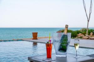 two drinks on a table next to a swimming pool at Dakhla South Bay in Dakhla