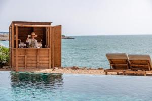 a bar on the beach next to a swimming pool at Dakhla South Bay, WorldHotels Distinctive in Dakhla