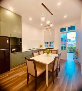 a kitchen and dining room with a table and chairs at Fa's House Hue in Thôn Kim Long (1)