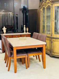 a dining room table with chairs and a dresser at WisTree Luxury Service Apartment-Bkc in Mumbai