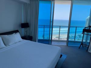 a bedroom with a bed and a view of the ocean at H Luxury Apartment at Surfers Paradise High floor in Gold Coast
