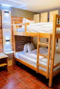 two bunk beds in a room with a brick wall at Villa Etelvina in Torotoro