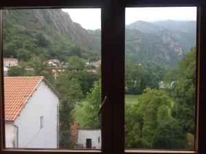 a window with a view of a mountain at Ceraca in Pola de Somiedo