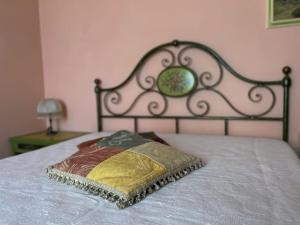 a pillow on a bed with a metal head board at La Terrazza in Pietrasanta