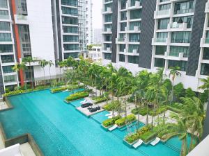 an aerial view of a resort swimming pool with palm trees at Grand Medini by JBcity Home in Nusajaya