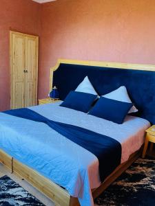 a blue bed with blue pillows in a bedroom at Villa Paradis in Marrakech