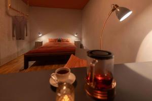 a room with a bed and a table with a lamp at 3-Zi-Wohlfühl-Oase „Down2Earth“ in Leonberg