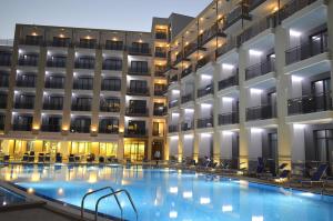 a hotel swimming pool in front of a building at Arena Mar Hotel and SPA in Golden Sands