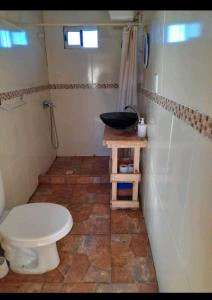 a bathroom with a toilet and a sink at Cabaña Balneario buenos aires in Balneario Buenos Aires