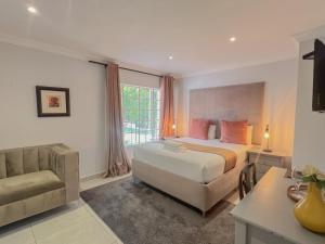 1 dormitorio con 1 cama, 1 silla y 1 ventana en Amoris Guesthouse - In Brooklyn, en Pretoria