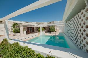 a swimming pool in the backyard of a house at La Peschiera in Monopoli