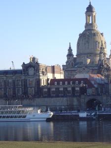 a cruise ship in the water in front of a building at Fewo DD- Wilschdorf in Dresden