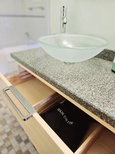 a bathroom counter with a bowl sink on it at Countryside Retreat - Fire Pit, Pool, Movie & Game Room in Lottsburg