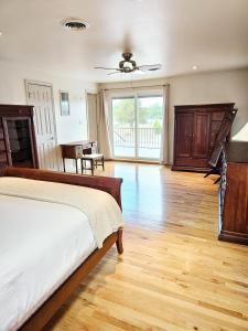 a bedroom with a bed and a wooden floor at Countryside Retreat - Fire Pit, Pool, Movie & Game Room in Lottsburg +47 photos