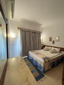 a bedroom with two beds and a window at 4S Hotel Dahab in Dahab