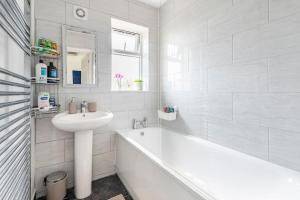 a white bathroom with a tub and a sink and a bath tub at Space House in Sheffield