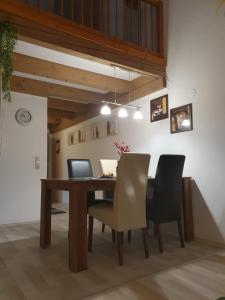 a dining room with a wooden table and chairs at Haus Sonntal in Bodenmais