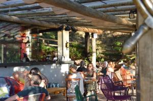a group of people sitting around a patio at Terra de Kurí in Espirito Santo Do Pinhal