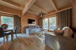 a living room with a couch and a table at Tatra Wood House Boutique in Zakopane