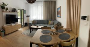 a living room with a table and a couch at Apartmán Sirius in Štôla