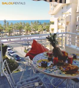 a table with food on top of a balcony at Blue Sky Berlin - Passeig Jaume I in Salou