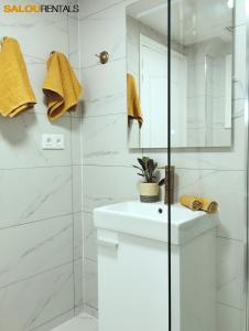 a bathroom with a white sink and a shower at Blue Sky Berlin - Passeig Jaume I in Salou