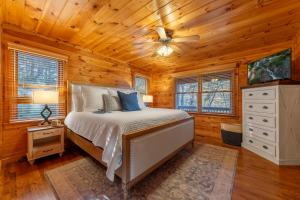 a bedroom with a bed and a ceiling fan at Beautiful 4BR Mountain View Cabin A Retreat for Everyone in Murphy