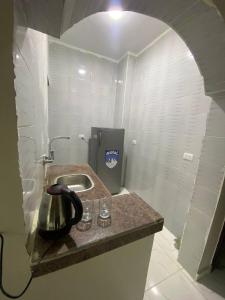 a kitchen with a sink and a tea kettle on a counter at SmSm Kato in Aswan +22 photos