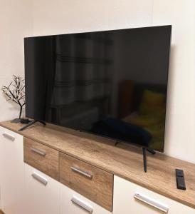 a flat screen tv sitting on top of a dresser at Vasari Home in Meersburg