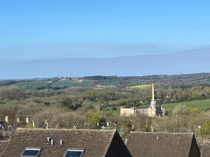 a view of a town with roofs and a building at Cosy two bed townhouse in Centre of C.Norton in Chipping Norton