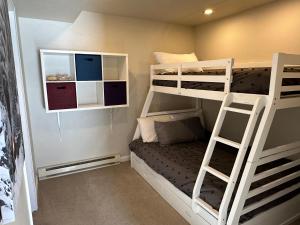 a bedroom with two bunk beds and a ladder at Purgatory Resort Ski In Ski Out in Durango