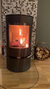 a fireplace with a fire in it in a room at Skogstad Ferie og fritid in Tromsø