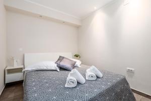a bedroom with a bed with towels on it at Apartment Srok, Relax in Kastav +24 photos