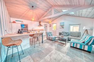 a kitchen and living room with a table and chairs at Villa Orkagna in Perros-Guirec