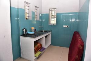 a small bathroom with a sink and a counter at Mel Rose Cottage Ooty in Ooty