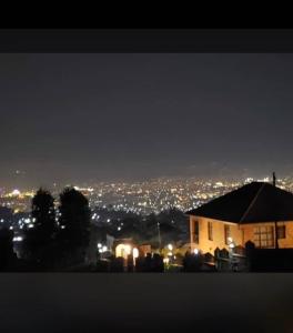a house with a view of a city at night at ADRIEL HOMES KIGALi in Kigali