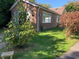 a house with a yard with a tree in front of it at Inviting 2-Bed fully Furnished House-High Wycombe in High Wycombe