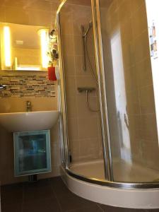a bathroom with a shower with a glass door at Inviting 2-Bed fully Furnished House-High Wycombe in High Wycombe