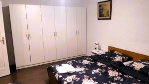 a bedroom with two beds and white cabinets at Mikesh in Virovitica