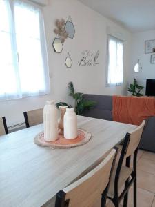 a dining room table with two candles on it at Proche aéroport à pied, O Nature in Tillé