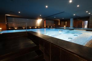 a large swimming pool in a building at night at DV Chalet Boutique Hotel & Spa in Madonna di Campiglio