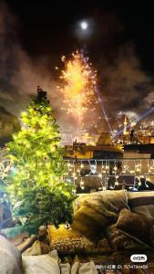 a christmas tree with fireworks in the background at Chelebi Cave House Hotel Over 6 Years Old in Göreme