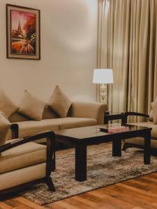 a living room with a couch and a coffee table at فندق فيلي Filly Hotel in Hail