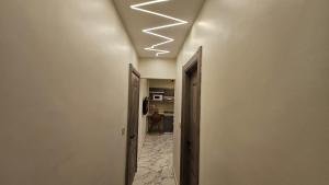 a hallway with a ceiling with lights on it at My Villa in Sheikh Zayed