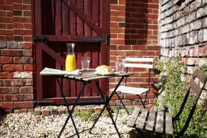 a table in front of a door with a bottle of juice at Sandbed House - Sleeps 6 in Bristol