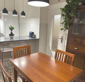 a kitchen with a wooden dining table and chairs at Opera in Love in Verona +20 photos