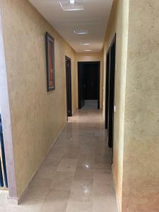 korytarz budynku z drzwiami i podłogą wyłożoną kafelkami w obiekcie Appartement De Luxe A Wilaya De Tetouan w mieście Tetuan
