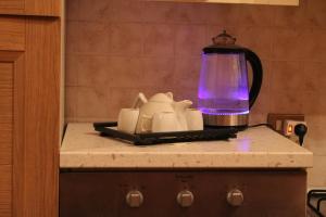 a kitchen counter with a coffee maker and a blender at Wildwood Cottage in Serramazzoni