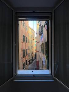 a window with a view of a city street at Iris 3: Un Fiore a Camogli in Camogli